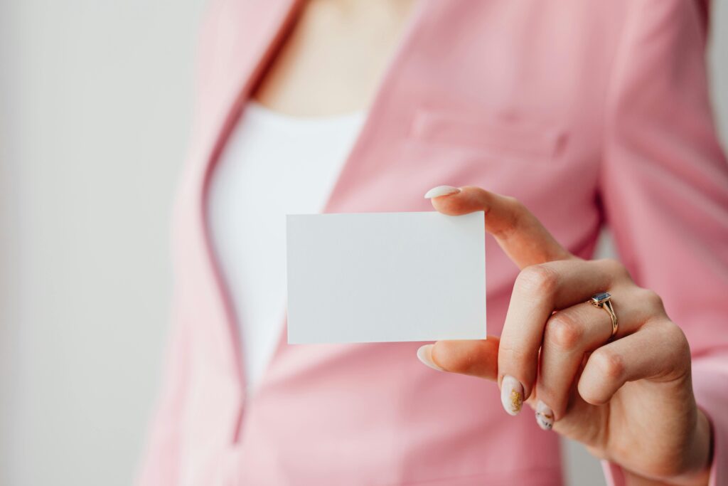 A brand engagement professional holding a blank business card