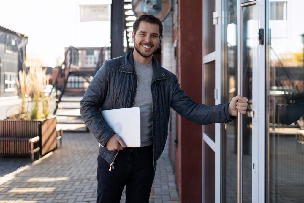 A salesperson holding the door