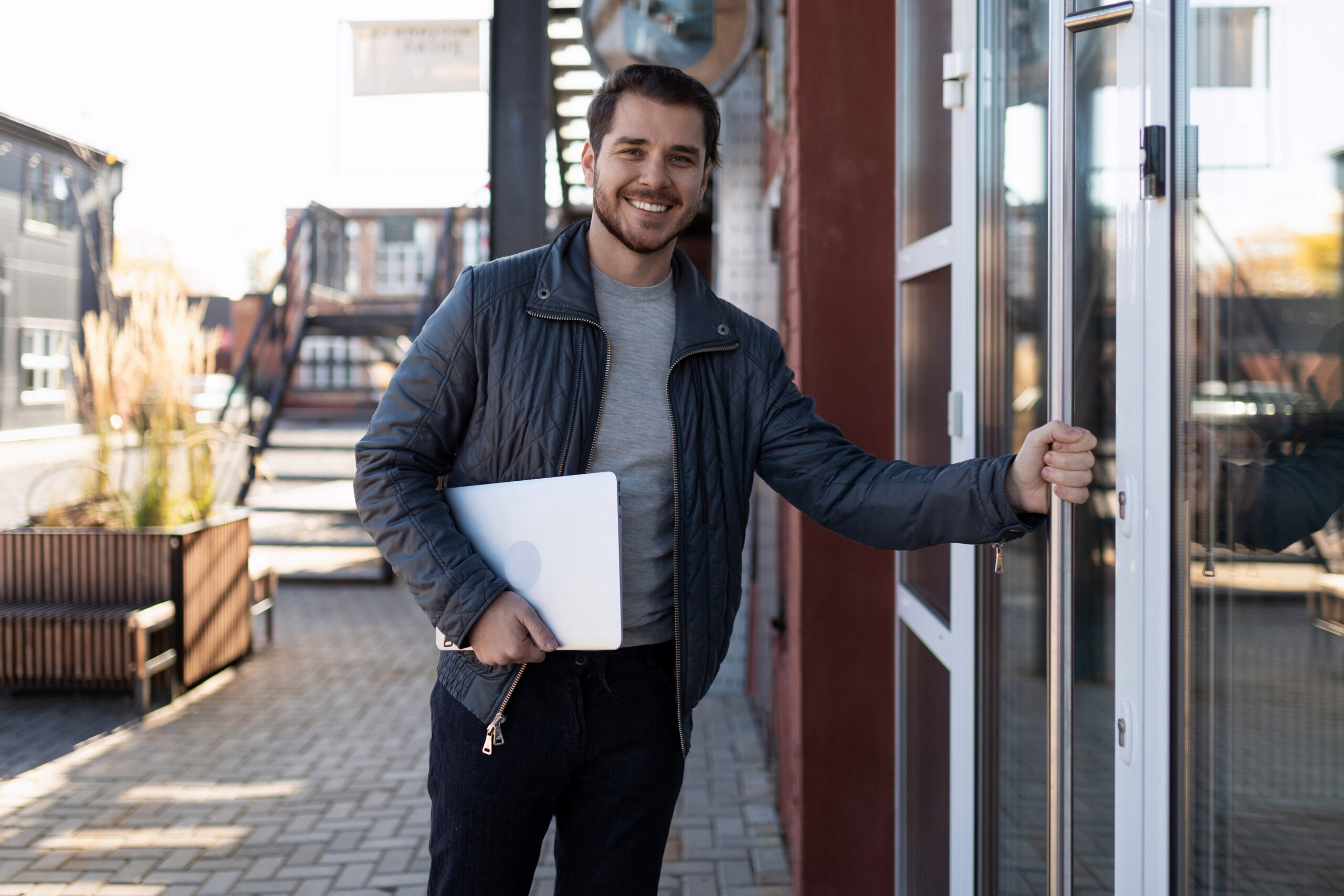 A salesperson holding the door